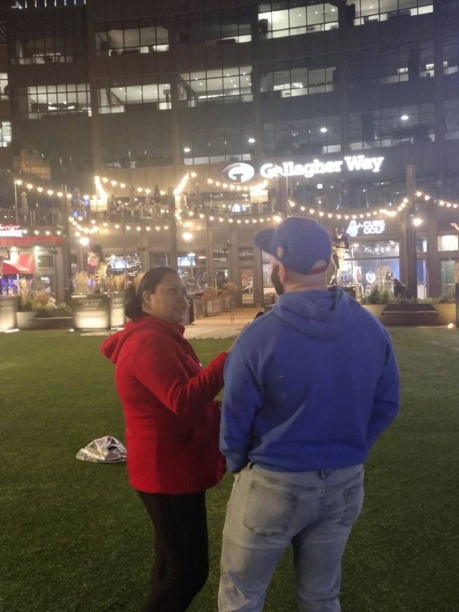 Elizabeth interviewing a cubs fan on the Hispanic Heritage Month