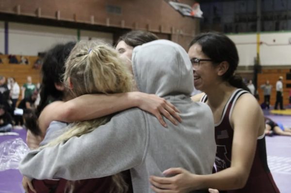 Morton girls wrestlers hug it out after a clean finish.