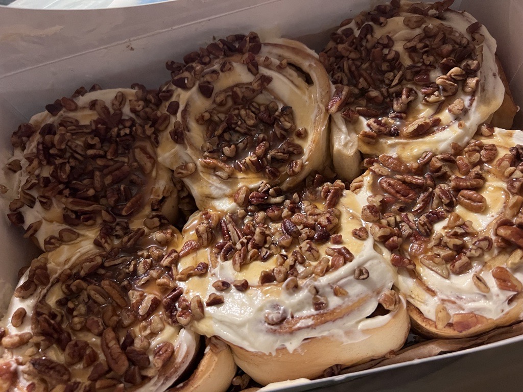 SWEET TREAT... A sweet set of cinnamon buns with glaze, nuts, and more cinnamon glaze inside. A tasty treat at the Cinnabon Bakery shop inside of the North Riverside Mall with different toppings for cinnamon rolls and a variety of drinking choices. 