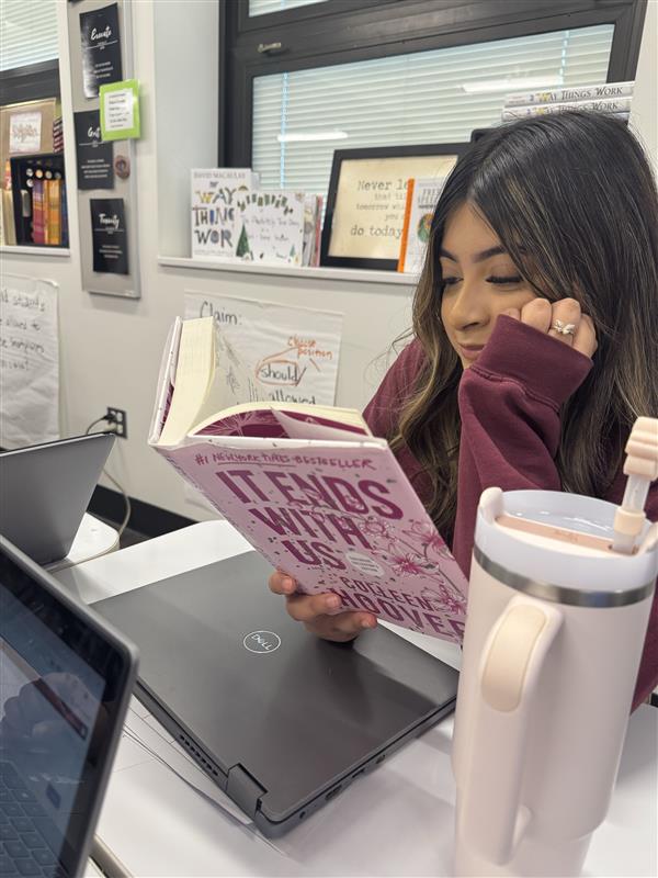 Senior Andrea Barajas reading "It Ends with Us"