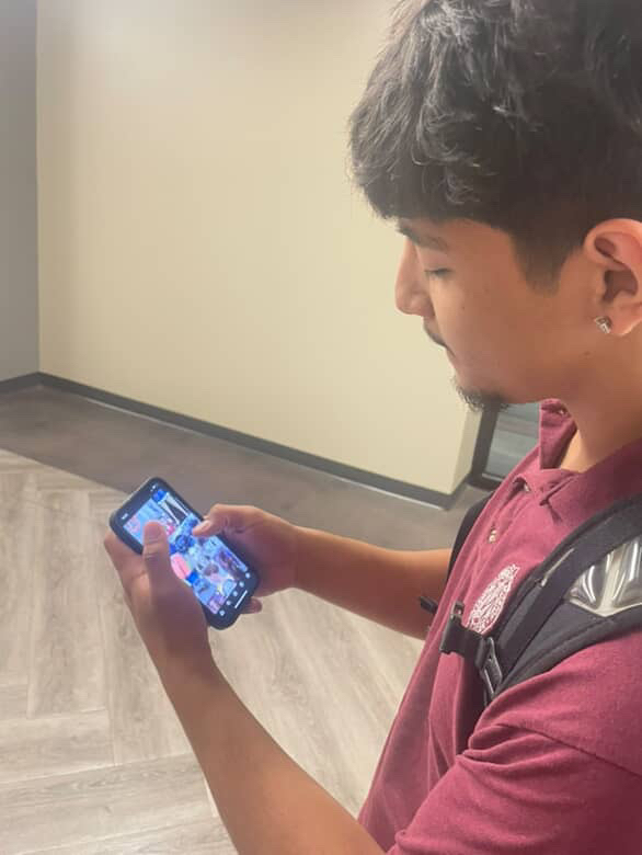 Senior, Angel Lopez scrolls Instagram.