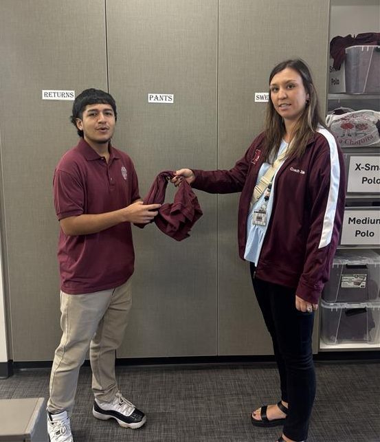 Mrs. Gill giving a Morton shirt to Adolfo 