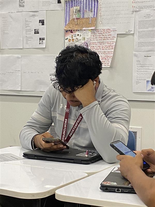 Cristian Moreno uses his phone in class. 