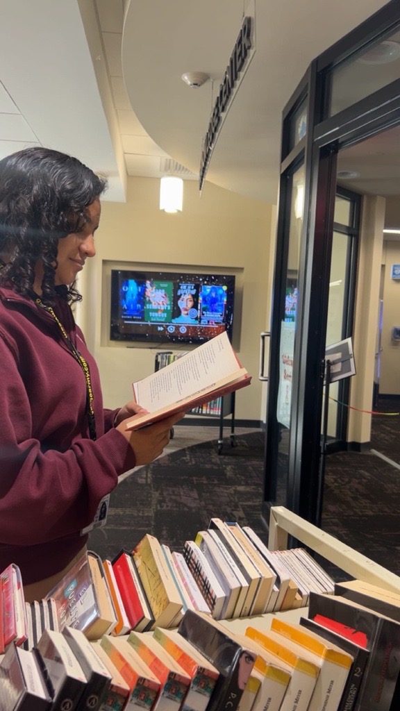 Karla Belmontes uses the library to read a book. 