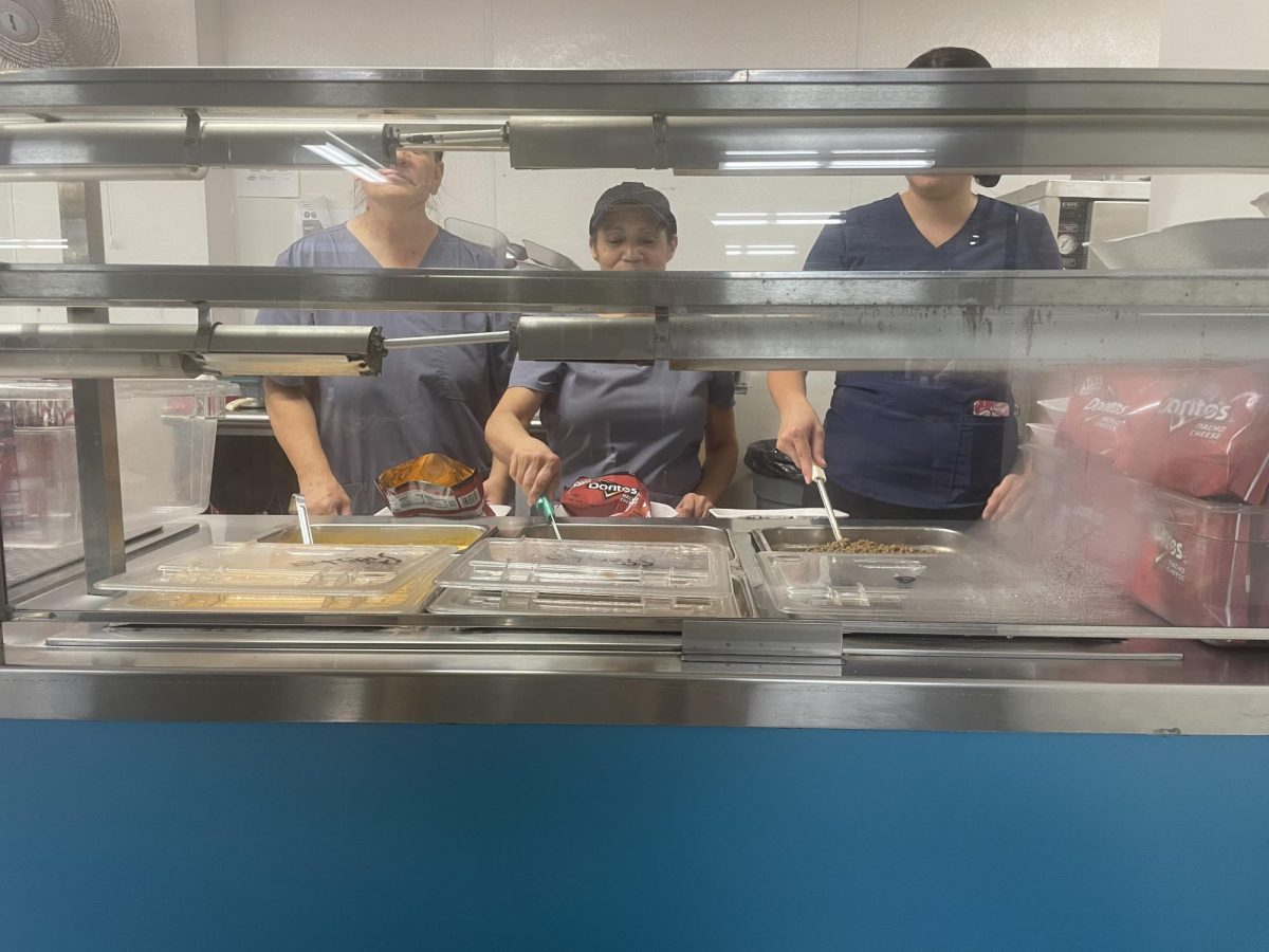 Lunch lady's getting ready to serve lunch.
