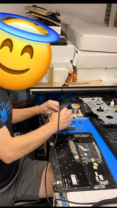 Senior Brandon fixing a school laptop-says Alexander