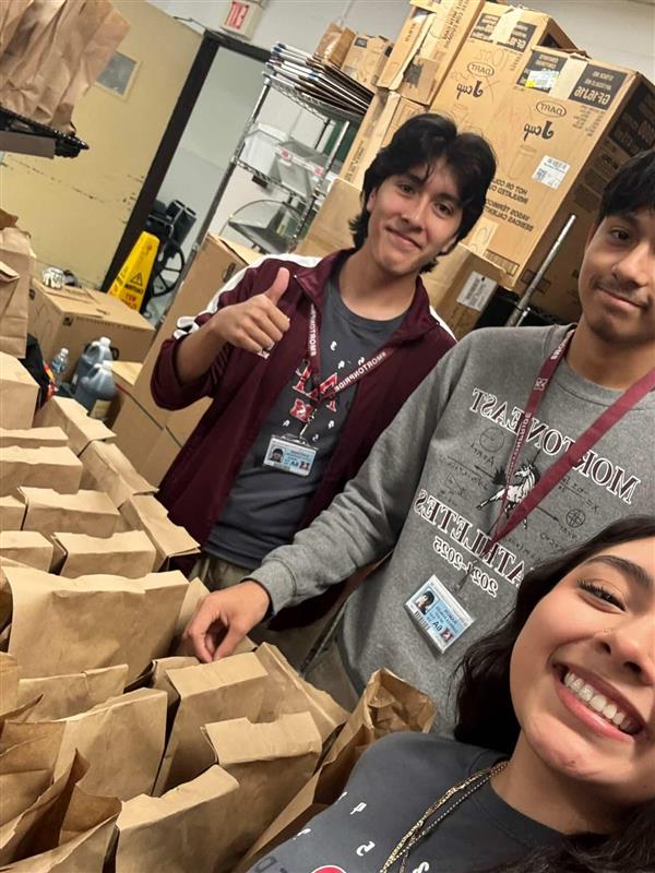 Morton East students pack snack sacks for the community.