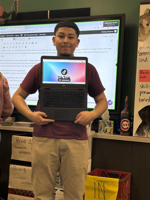 Senior Emanuel Leanos holds up TikTok as the year's Best Social Media Platform.