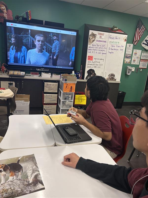 Adolfo Monroy Medina and Anthony Calderon watch Stranger Things in class.