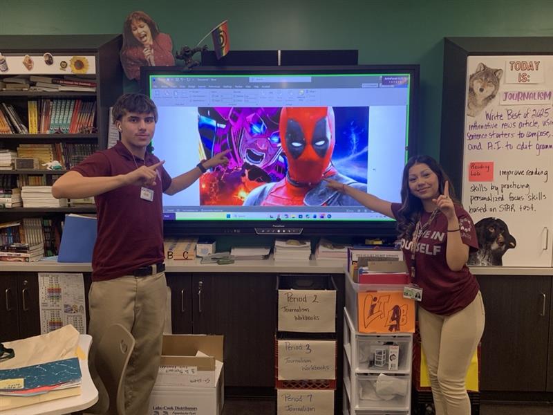 Juniors Damien Marillo and Natalie Nunez point to the number 1 hero and villain of the year. 