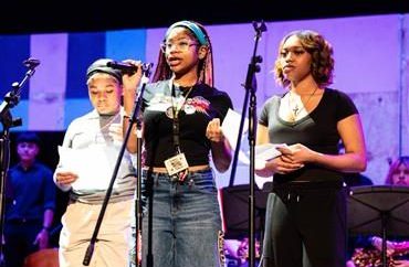 Three students read an original poem at the assembly. 