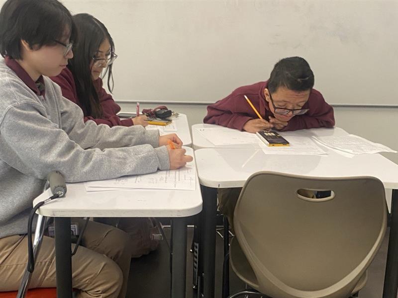 Seniors Jennifer Hernandez, Ms. Delalba, and Jonathan all work on their geometry as spring break approaches.  "I need some sleep; I'm going to sleep all break," said Hernandez.  "I'm going to work all break," said Delalba.  "I'm going to work too!" said Jonathan.  