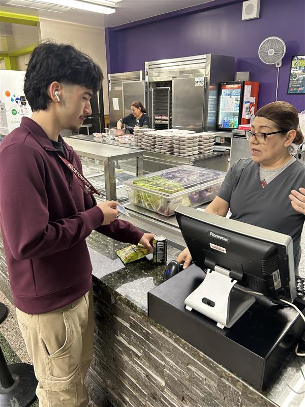 Ivan Haro buying snacks from the Morton East school cafeteria