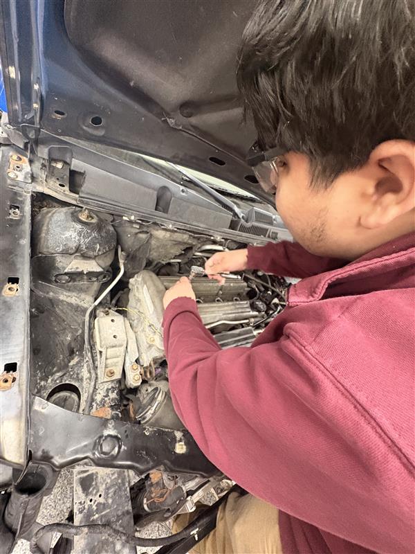 Jesus Salgado works hard in auto mechanics for a final project before spring break.  "The first thing I will do on spring break is take out my drivers license, so I can hang out with friends," said Salgado.