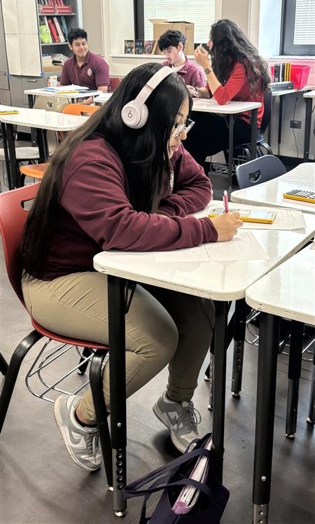Senior Jennifer Hernandez works on an Algebra 3 assignment; according to ChatGPT, about 75% of all high school math courses involve algebra.