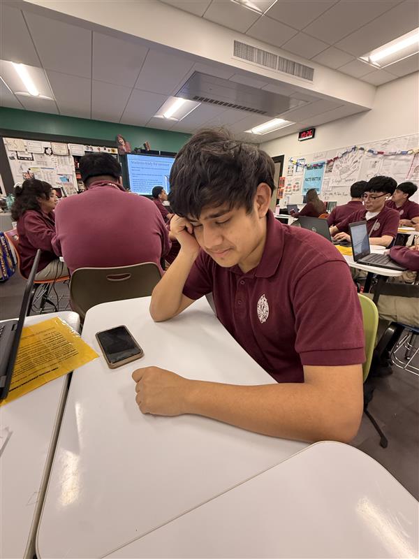 Aron Flores is seen sleeping in class instead of doing work. This is due to coming back from spring break.